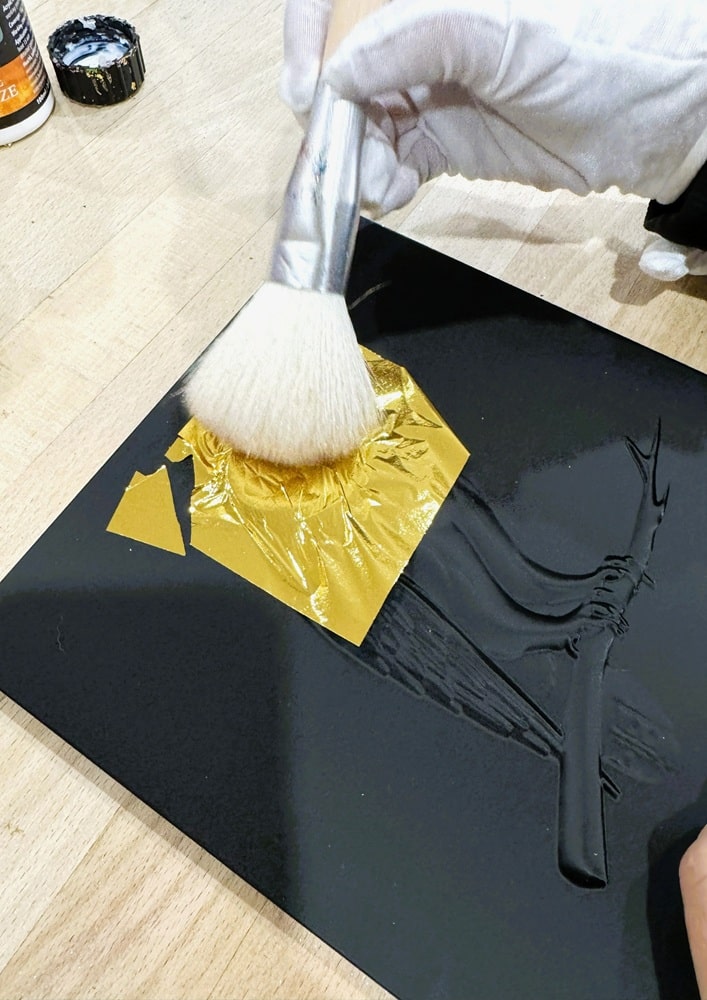Hand applied gold leaf detail